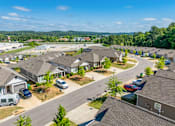 Thumbnail 46 of 47 - A residential area with houses and cars parked in front.