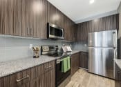 Thumbnail 11 of 73 - our apartments have a modern kitchen with stainless steel appliances at Scottsdale Hayden Townhomes, Scottsdale, AZ, 85257