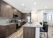 Thumbnail 16 of 73 - a kitchen with a large island with granite countertops  at Scottsdale Hayden Townhomes, Scottsdale, 85257
