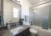 Thumbnail 48 of 73 - a bathroom with gray tile and a white toilet at Scottsdale Hayden Townhomes, Arizona, 85257