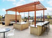 Thumbnail 73 of 81 - A patio with a table, chairs and a bar.