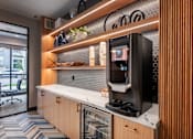 Thumbnail 30 of 81 - A modern kitchen with a countertop and a microwave.