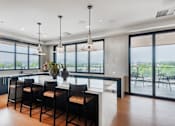 Thumbnail 40 of 81 - A modern kitchen with a large island and bar stools.