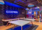 Thumbnail 45 of 81 - A room with a pool table and a neon sign that says "Good Vibes".