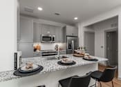Thumbnail 15 of 52 - A modern kitchen with a dining table set for two.