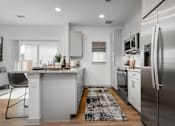 Thumbnail 19 of 52 - A modern kitchen with a large island and stainless steel appliances.