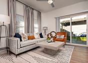 Thumbnail 9 of 52 - A modern living room with a grey couch, a white coffee table, and a floor lamp.