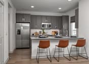 Thumbnail 5 of 52 - A modern kitchen with a bar stool.