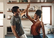 Thumbnail 4 of 11 - A man and a woman are dancing in a kitchen.