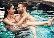 Thumbnail 11 of 11 - A man and woman in a pool.