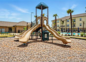 Thumbnail 13 of 33 - A playground with a slide and a tower. at Beau Chene Lake Charles Apartments, Los Angeles, 70605