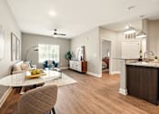 Thumbnail 23 of 33 - A modern kitchen with a dining table and chairs. at Beau Chene Lake Charles Apartments, Lake Charles