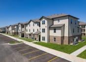 Thumbnail 1 of 12 - a row of apartment buildings at Beau Chene Lake Charles Apartments in Lake Charles, LA 70605