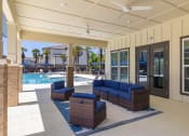 Thumbnail 5 of 12 - patio area of clubhouse with couches and a pool at Beau Chene Lake Charles Apartments in Lake Charles, LA 70605