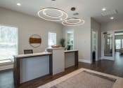Thumbnail 6 of 12 - an office lobby with a reception desk and a mirror at Beau Chene Lake Charles Apartments in Lake Charles, LA 70605