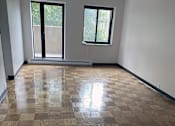 Thumbnail 9 of 15 - a living room with a wooden floor and a window at Clinton Towers, Bronx, NY, 10457