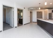 Thumbnail 18 of 81 - Modern open-concept kitchen and living area with stainless steel appliances.