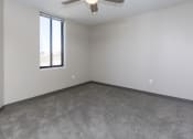 Thumbnail 23 of 81 - Bright, vacant bedroom with neutral walls and carpet flooring.