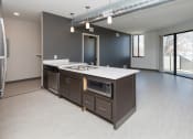 Thumbnail 30 of 81 - Modern open-concept kitchen and living area with stainless steel appliances.