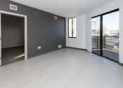 Thumbnail 40 of 81 - Modern open-concept kitchen and living area with stainless steel appliances.