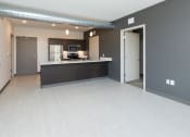 Thumbnail 41 of 81 - Modern open-concept kitchen and living area with stainless steel appliances.