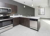 Thumbnail 50 of 81 - Modern open-concept kitchen and living area with stainless steel appliances.