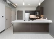 Thumbnail 52 of 81 - Modern open-concept kitchen and living area with stainless steel appliances.