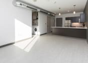 Thumbnail 55 of 81 - Modern open-concept kitchen and living area with stainless steel appliances.