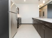 Thumbnail 62 of 81 - Modern open-concept kitchen and living area with stainless steel appliances.