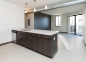 Thumbnail 63 of 81 - Modern open-concept kitchen and living area with stainless steel appliances.