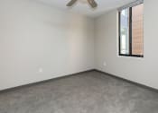 Thumbnail 71 of 81 - Bright, vacant bedroom with neutral walls and carpet flooring.