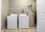 Thumbnail 17 of 54 - A white washer and dryer in a small laundry room.