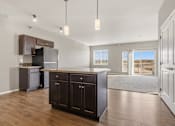 Thumbnail 20 of 54 - A kitchen with dark brown cabinets and a black refrigerator.