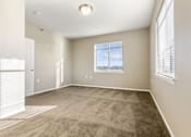 Thumbnail 21 of 54 - A room with a carpeted floor and a window with blinds.