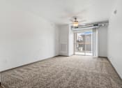 Thumbnail 9 of 57 - A room with a carpet floor and a ceiling fan.