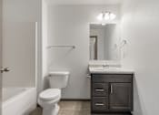 Thumbnail 11 of 57 - A white toilet sits next to a sink in a bathroom.