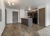 Thumbnail 4 of 57 - A kitchen area with a wooden floor and a bar area.