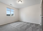 Thumbnail 26 of 50 - A room with a carpeted floor and a window.