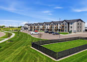 Thumbnail 8 of 44 - A large building with a black fence in front of it.
