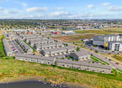 Thumbnail 7 of 64 - A bird's eye view of a large building complex with a body of water in the foreground.