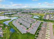 Thumbnail 26 of 26 - A bird's eye view of a residential area with houses and a river.