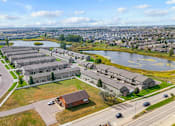 Thumbnail 62 of 64 - A large building complex is situated next to a body of water.