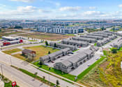 Thumbnail 63 of 64 - A large building complex is situated next to a body of water.