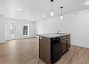 Thumbnail 2 of 44 - an empty living room with a kitchen with a sink and a counter top