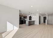 Thumbnail 12 of 68 - A modern kitchen with a white wall and wooden flooring.