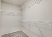 Thumbnail 21 of 68 - Empty room with white walls and shelves.