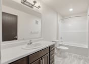 Thumbnail 22 of 68 - A white bathroom with a sink, toilet, and bathtub.