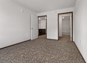 Thumbnail 8 of 44 - A room with a carpeted floor and two doors.