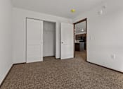 Thumbnail 9 of 44 - A room with a carpeted floor and a white door.