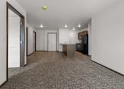 Thumbnail 6 of 44 - A spacious, empty room with a grey carpet and white walls.